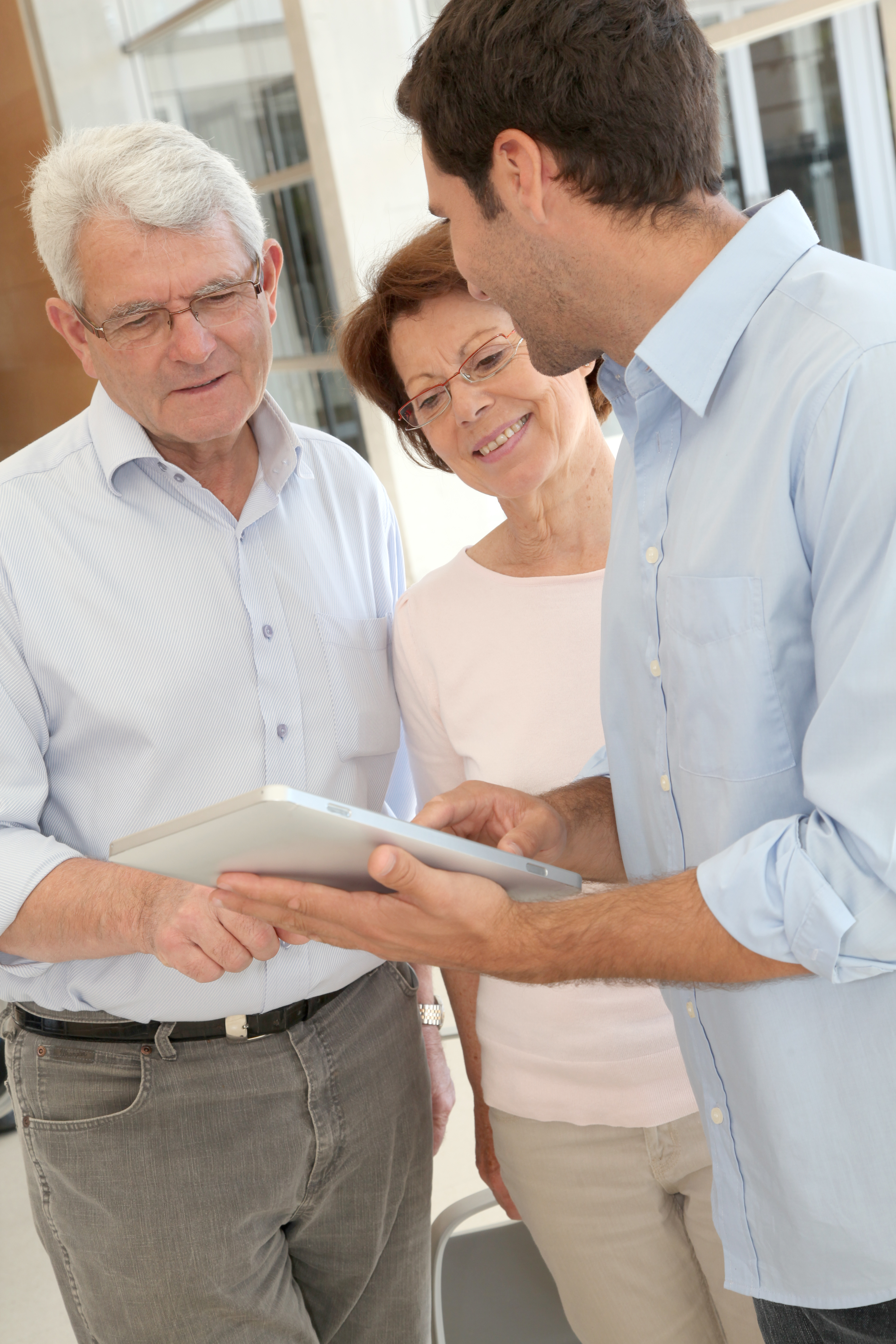 Senior people learning how to use electronic tablet
